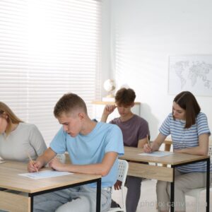 students seated at desks taking exam